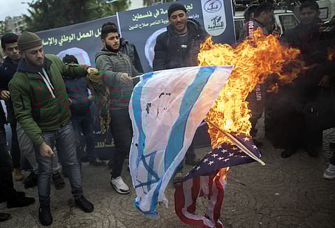 Palestinians burn US and Israeli flags as they attend a mourning tent held by Palestinian factions for Qassem Soleimani (Photo| AP)