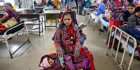A mother waits for treatment of her child at JK Lon hospital in Kota, Rajasthan. (Photo | PTI)