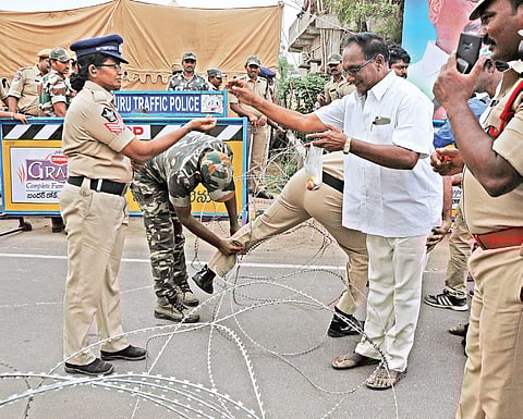 A protester offers flowers to a policewoman (Photo | EPS)
