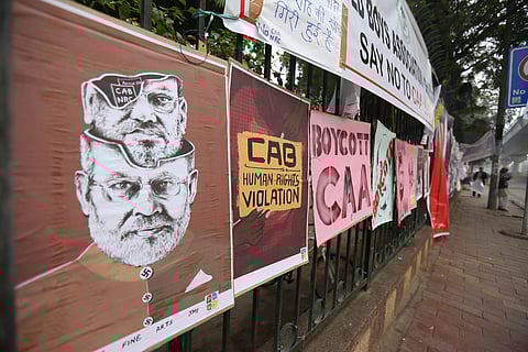Banner pasted on a wall during a protest against Citizenship Act outside the Jamia Millia Islamia university in New Delhi. (Photo | Arun Kumar P/EPS)