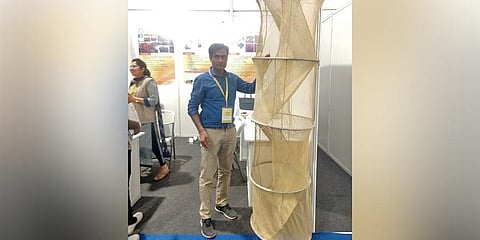 Scientist Mahipal Meena displays a model of the expandable emergency chute at the Pride of India Expo at the 107th Indian Science Congress
