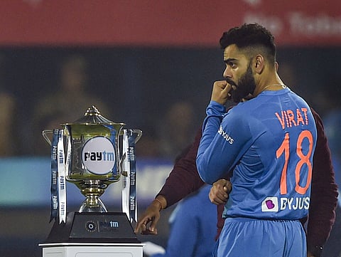 Indian skipper Virat Kohli looks on at the trophy before the start of 1st T20 match against Sri Lanka at Barsapara Cricket Stadium in Guwahati. (Photo | PTI)