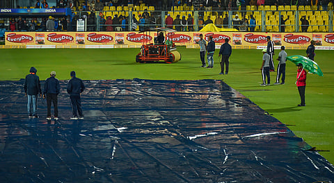Groundsmen cover their pitch due to rain before the start of 1st T20 match between India and Sri Lanka at Barsapara Cricket Stadium in Guwahati, Sunday. (Photo | PTI)