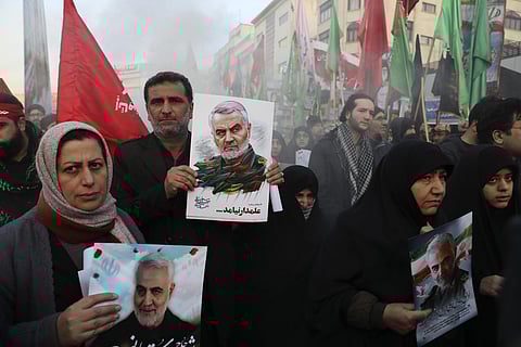 Mourners holding posters of Iranian Gen. Qassem Soleimani attend a funeral ceremony for him and his comrades, who were killed in Iraq in a US drone strike on Friday (Photo| AP)