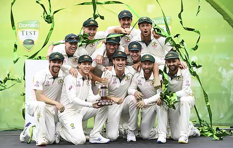 Australian players pose for a team photo as they celebrate winning the test match and series on day four of the third cricket test match between Australia and New Zealand. (Photo | AP)