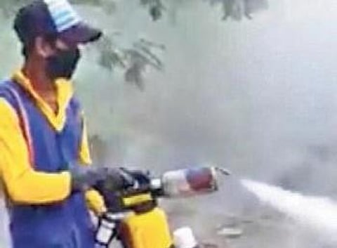 A BeMC worker using a hand held fogging machine | Express