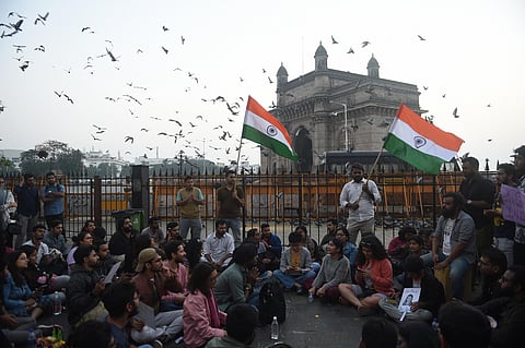 Students stage a protest near the Gateway of India to condemn the violence at Delhi's Jawaharlal Nehru University in Mumbai. (Photo | PTI)