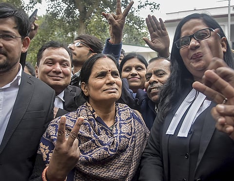 Nirbhaya case victim's mother flashes the victory sign along with lawyers after a court issued death warrants against the four convicts in the case outside Patiala House Courts in New Delhi Tuesday Jan. 7 2020. (Photo | PTI)