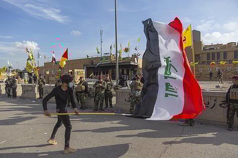 A man waves the Iraqi flag (Photo | AP)
