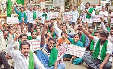 Members of Karnataka Rajya Raita Sangha and Hasiru Sene stage a dharna at BDA office in Bengaluru on Tuesday demanding relief for land owners of Peripheral Ring Road | Express