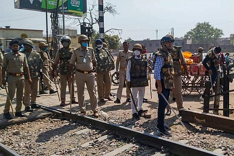 Police personnel inspect the area after a protest against the state government over the death of a 19-year-old Dalit woman. (Photo | PTI)