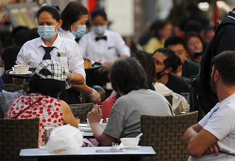 In this Sept. 22, 2020 file photo, staff wear face masks as they serve in a restaurant in Soho in London. (Photo | AP)