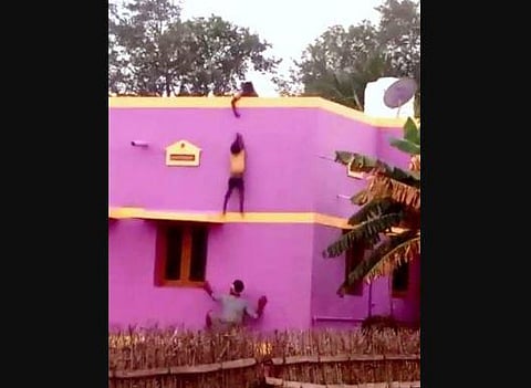 Mohammed Salik catching the little boy who slipped from terrace near Manapparai in Tiruchy on Sunday. (Express | M K Ashok Kumar)