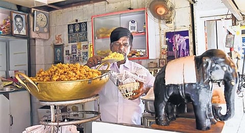 B Kannan, proprietor of the 105-year-old Yanai Mark Nei Mittai Kadai fills up a ‘koodai’ with their trademark ‘periya boondhi’ | MK Ashok Kumar