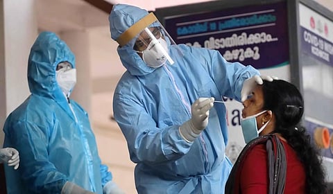 Health workers collect swab sample from a woman for COVID-19 tests in Kerala. (Photo | PTI)