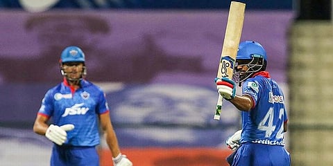 Delhi Capitals' Shikhar Dhawan raises his bat after scoring a half century against Mumbai Indians. (Photo | PTI)