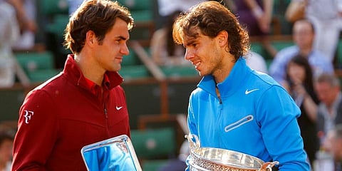 In this June 5, 2011, photo, Rafael Nadal and Roger Federer pose with their trophies after the men's final match for the French Open tennis tournament at Roland Garros stadium. (Photo | AP)