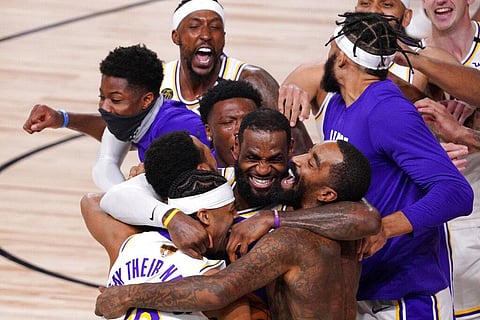 Los Angeles Lakers' LeBron James (23) celebrates with his teammates after the Lakers defeated the Miami Heat (Photo | AP)