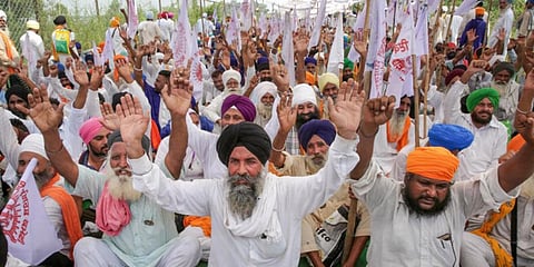 Farmers block the Amritsar-Delhi national highway during a protest against the central government, at Beas in Amritsar. (Photo | PTI)