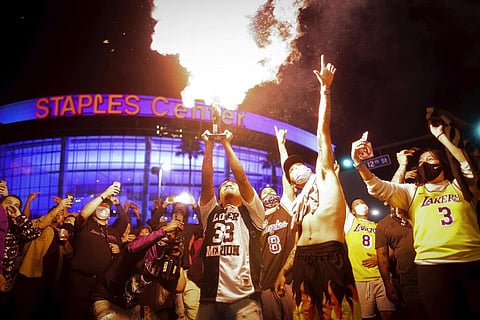 Los Angeles Lakers fans celebrate outside of Staples Center, Sunday, Oct. 11, 2020, in Los Angeles. (Photo | AP)