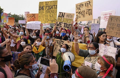 Women’s rights activists and others protesting against gender based violence hold placards outside the Parliament in Dhaka. (Photo | AP)
