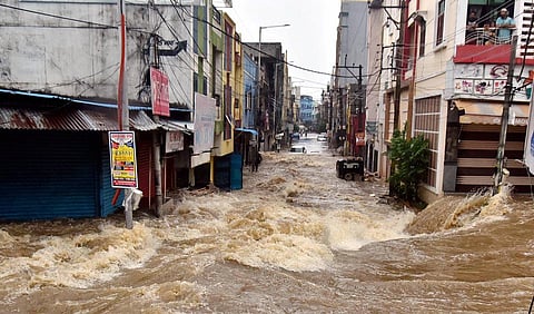 Rainwater gushes through a street following heavy rains, at Falaknuma, in Hyderabad. (Photo | PTI)