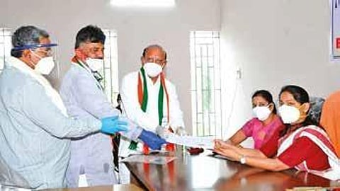 Former minister T B Jayachandra files his nomination papers accompanied by KPCC president D K Shivakumar and opposition leader Siddaramaiah on Thursday