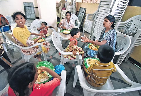Children have a meal at a GHMC relief camp near Moosarambagh in Hyderabad | S SENBAGAPANDIYAN