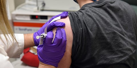 The first patient enrolled in Pfizer's COVID-19 coronavirus vaccine clinical trial receives an injection. (Photo| AP)