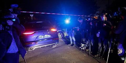 A police car enters the perimeter after a history teacher who opened a discussion with students on caricatures of Islam's Prophet Muhammad was decapitated. (Photo| AP)
