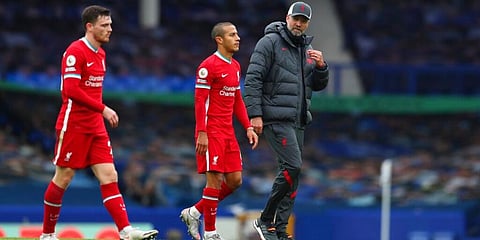 Liverpool manager Jurgen Klopp walks off the pitch with Andrew Robertson (L) and Thiago after Premier League match against Everton at Goodison Park stadium. (Photo | AP)