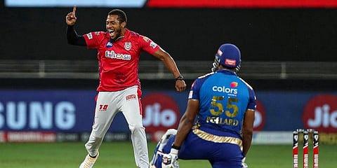 Kings XI Punjab bowler Chris Jordon celebrates the wicket of Mumbai Indians player Keiron Pollard during their IPL T20 match at Dubai International Cricket Stadium. (Photo | PTI)