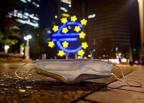 A face mask was left behind near the Euro sculpture in Frankfurt, Germany. (Photo | AP)