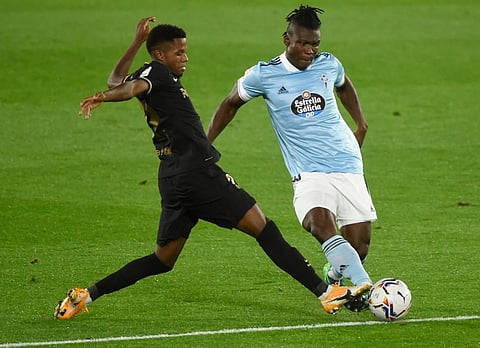Barcelona's Spanish forward Ansu Fati (L) vies with Celta Vigo's Ghanaian defender Joseph Aidoo. (Photo | AFP)