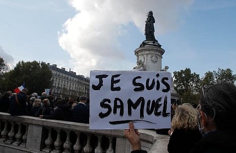 People gather on Republique square, one with a poster reading 'I am Samuel' for a demonstration in Paris. (Photo | AP)