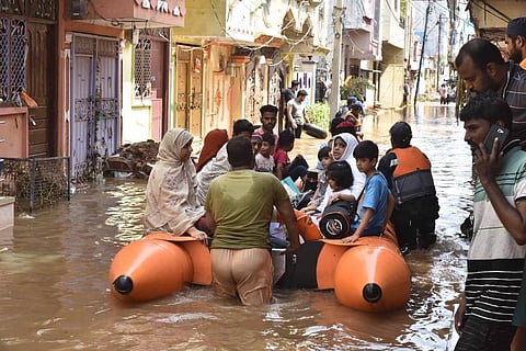 Residents of Hafizbaba nagar being shifted by DRF personnel in a boat to safer place in Hyderabad on Sunday. (Photo | EPS)