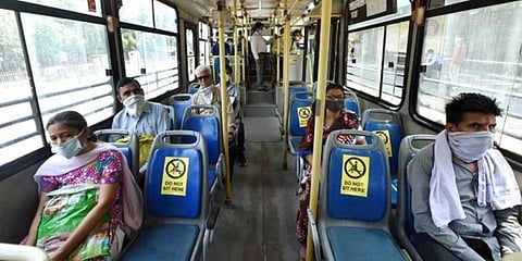 Passengers maintain social distancing while sitting in a DTC bus in New Delhi. (Photo | PTI)
