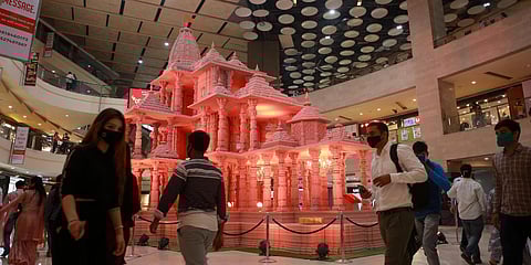 Visitors pass by Ayodhya’s Ram Temple model in background at the Pacific Mall in Tagore Garden. (Photo| EPS)