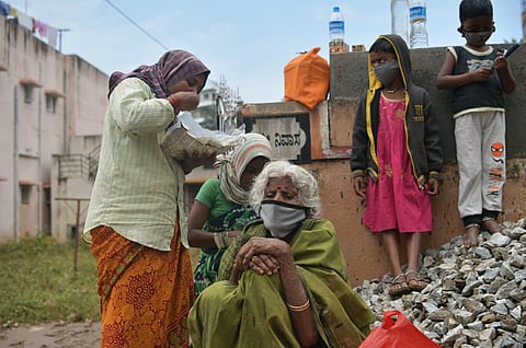People pick up pieces in at Dattatreya Nagar and Guruduttnagar in Bengaluru on Saturday. (Photo | Meghana Sastry, EPS)
