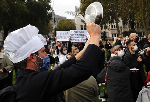 Hospitality workers protest in Parliament Square in London. (Photo | AP)