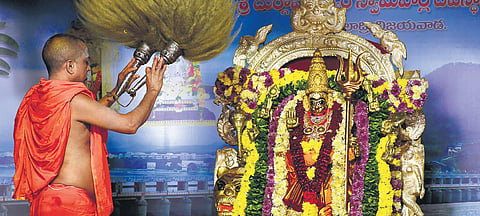 A priest performing Pavalimpu Seva to Goddess Kanaka Durga adorned as Sri Durga Devi at Indrakeeladri in Vijayawada. (Photo | Prasant Madugula, EPS)