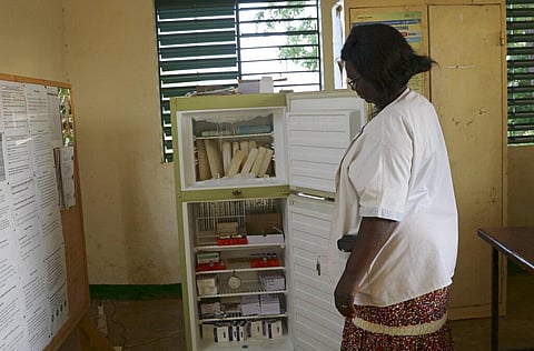 Marguerite Ouangraoua, a nurse at the health clinic in Zeguedessin village on the outskirts of Burkina Faso's capital, Ouagadougou, opens the fridge where the clinic keeps the vaccines. (Photo | AP)