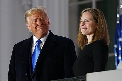 President Donald Trump and Amy Coney Barrett stand on the Blue Room Balcony after Supreme Court Justice Clarence Thomas administered the Constitutional Oath to her. (Photo | AP)