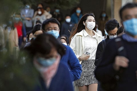 Commuters wearing face masks to help curb the spread of the coronavirus walk out from a subway station during the morning rush hour in Beijing, Tuesday, Oct. 27, 2020. (Photo | AP)