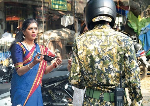 A woman argues with a BBMP marshal on being fined for not wearing a mask in Bengaluru. Marshals are having a tough time enforcing Covid norms | meghana Sastry