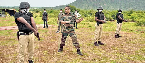 Prakasam SP Siddharth Kaushal giving instructions to SWAT commandos at a firing range in Chimakurthy on Friday. (Photo | EPS)