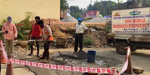 GHMC workers engaged in roads restoration works in Hyderabad on Thursday. (Photo| EPS)