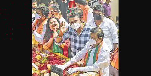 Sandalwood actors Amulya and Darshan greet voters during a roadshow for BJP’s RR Nagar candidate N Muniratna, in Bengaluru on Friday. | Meghana Sastry