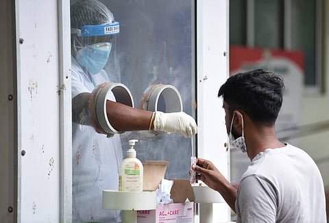 Healthcare staff collects nasal swabs for Covid-19. (Photo | U Rakesh Kumar, EPS)