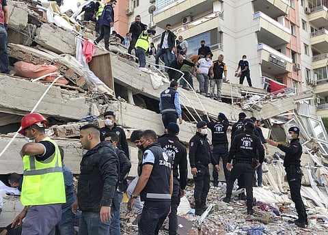 Rescue workers and local people try to save residents trapped in the debris of a collapsed building, in Izmir, Turkey, Friday, Oct. 30, 2020. (Photo | AP)